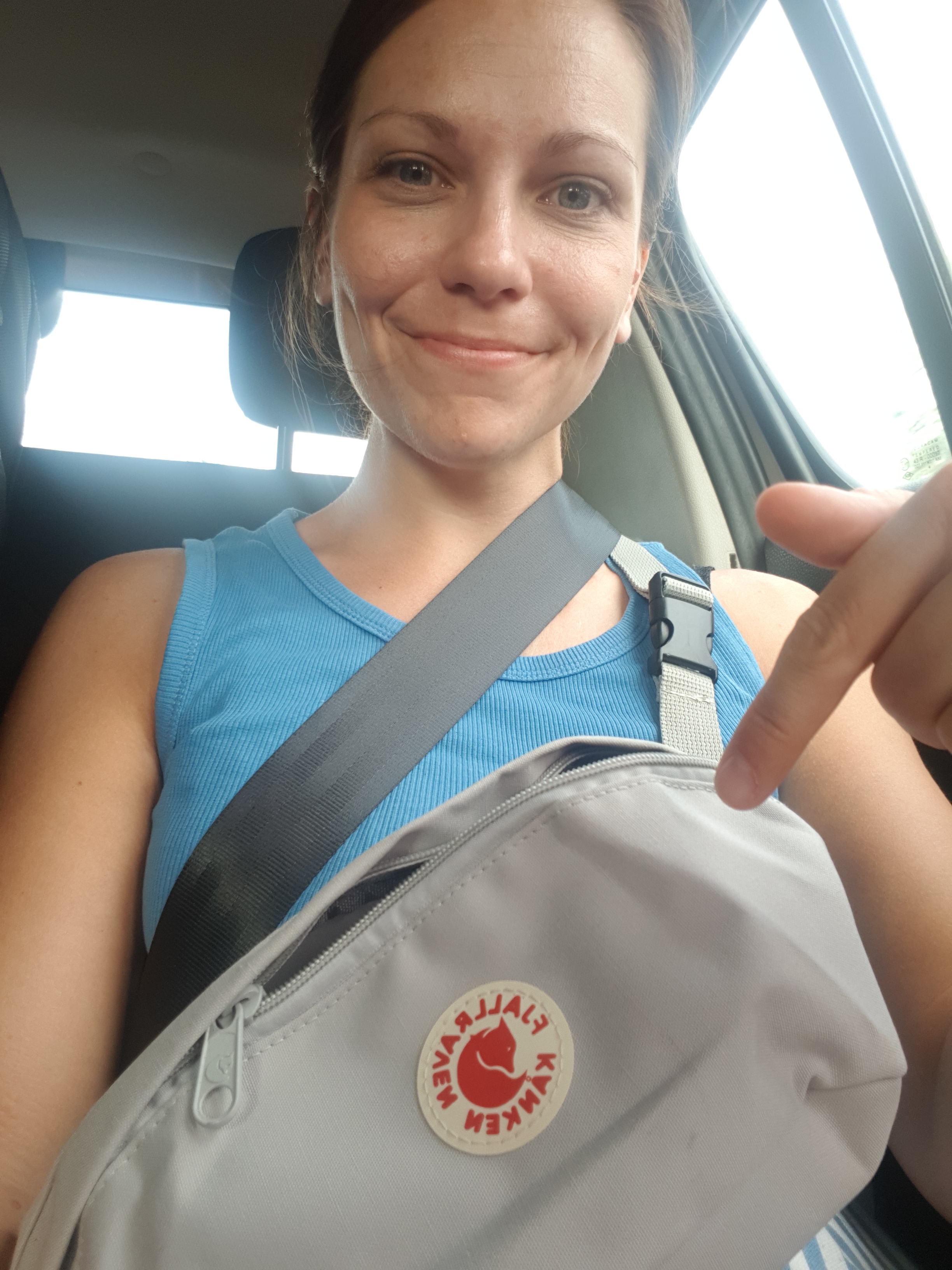 Digital Nomad in a car, smiling at the camera, ready for a new adventure, exemplifying the mobile and flexible lifestyle of remote work.