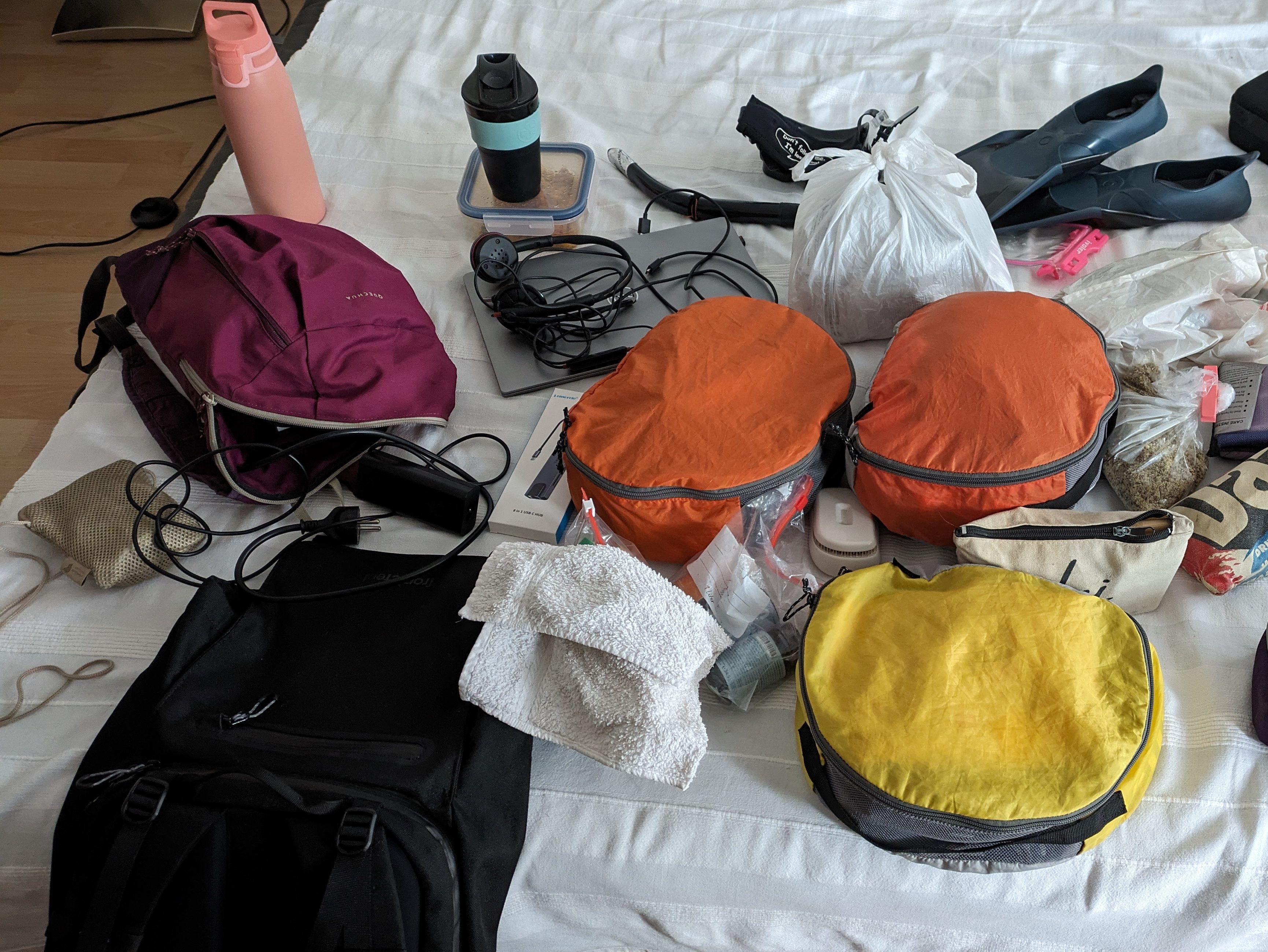 Packing essentials for a digital nomad, including bags, clothes, and travel gear.
