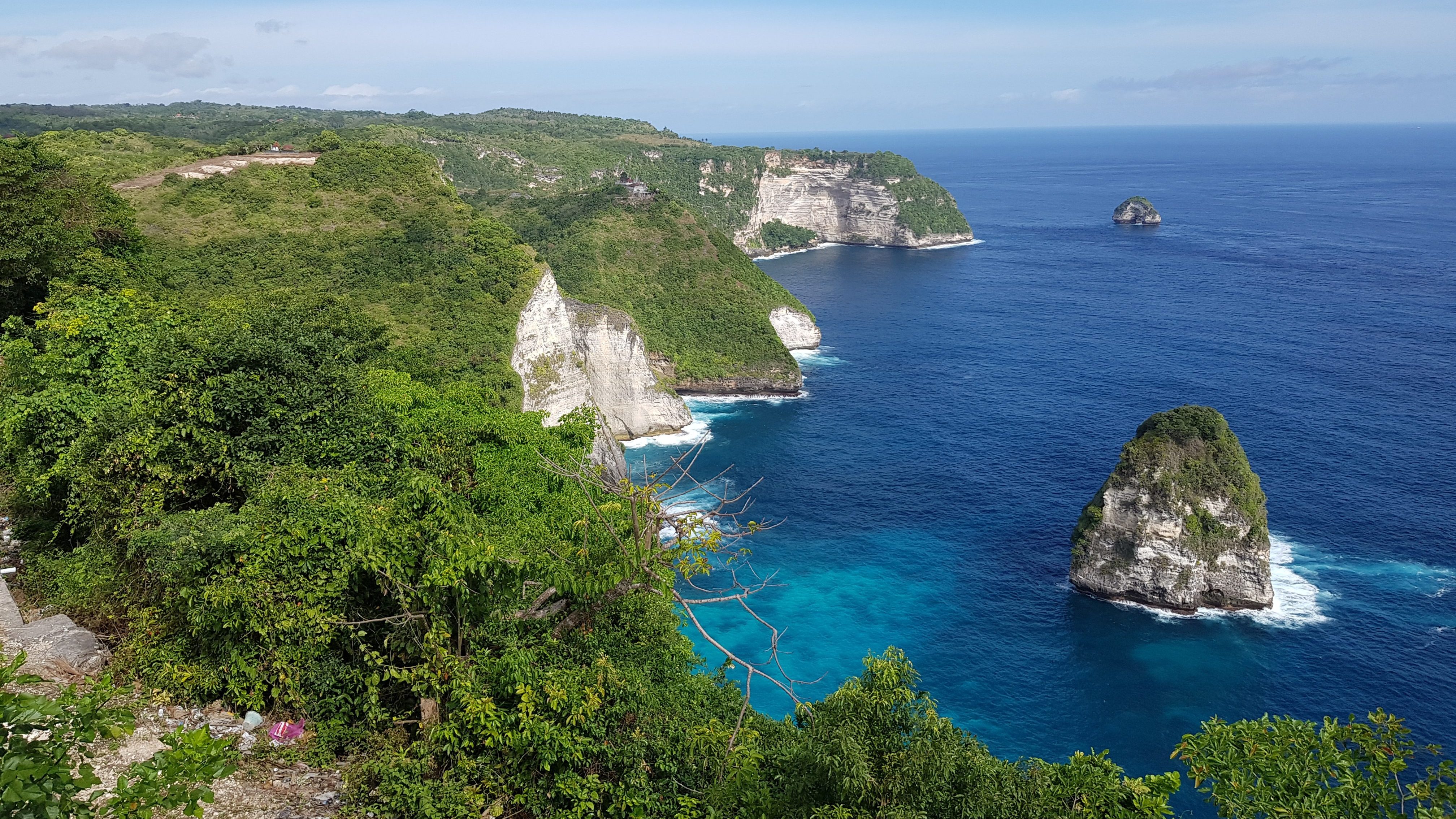 Tourists exploring the breathtaking cliffs of Nusa Penida, Bali
