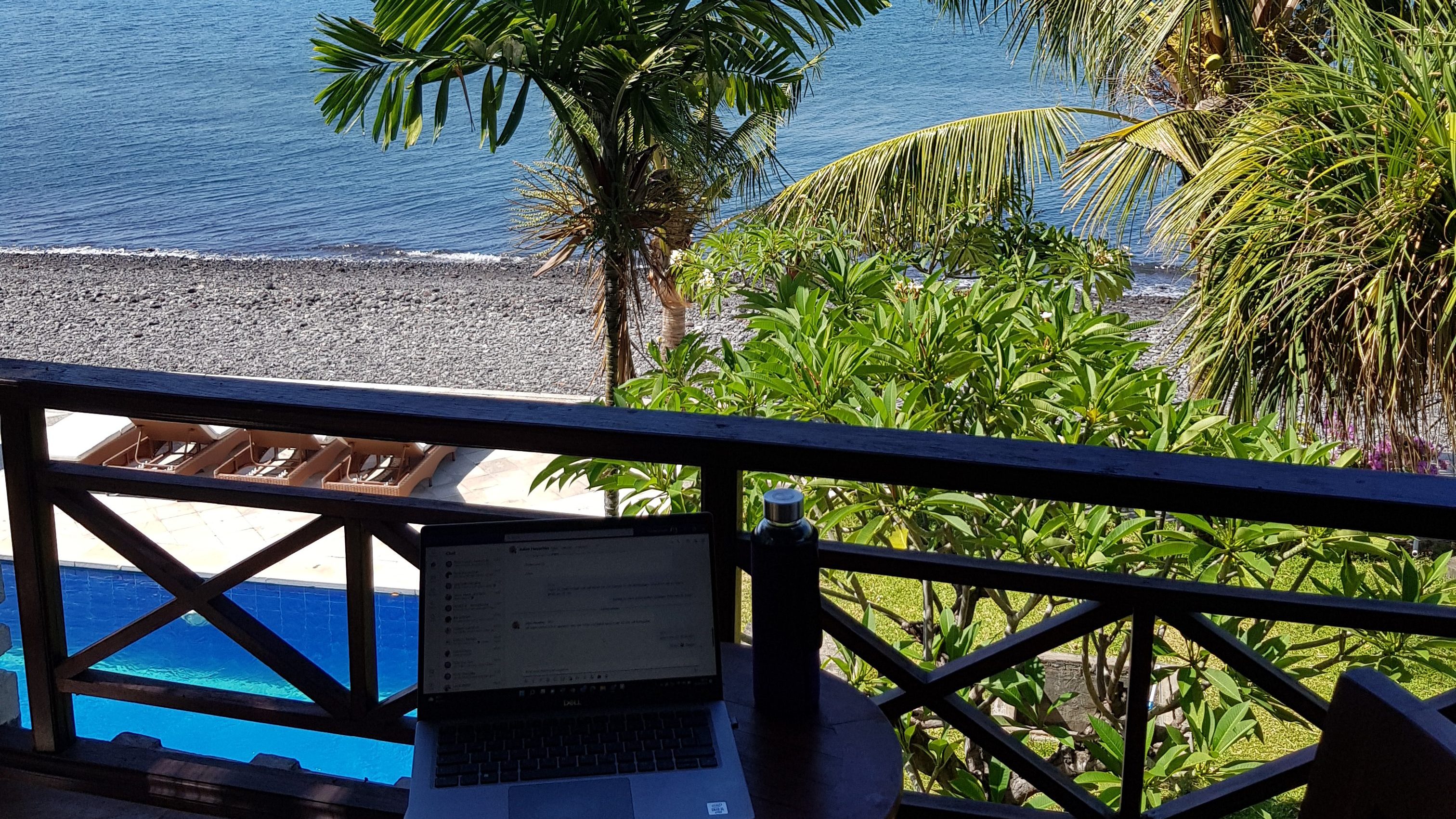 Laptop and coffee on the beach in Bali, ideal for digital nomads
