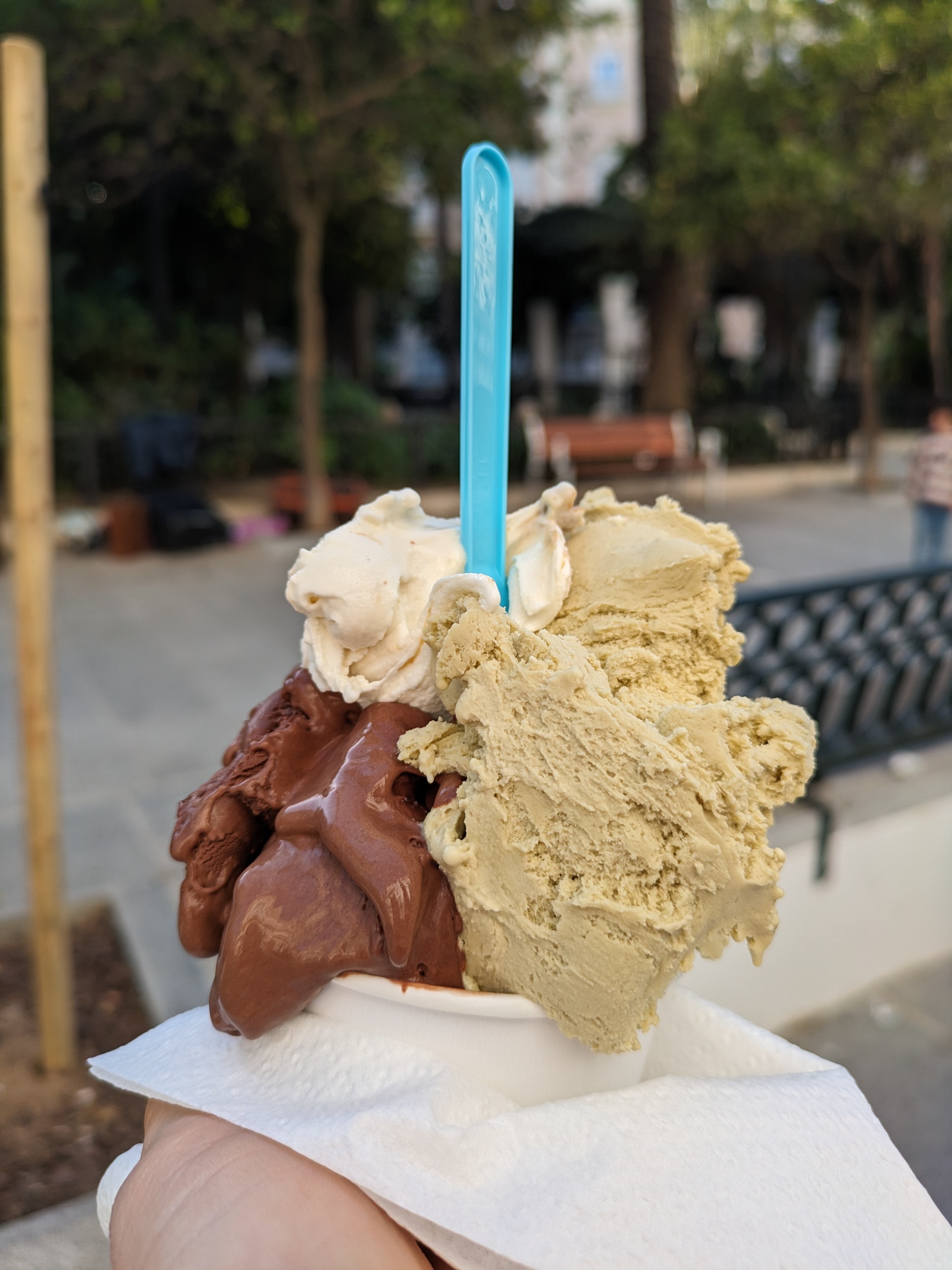 Close-up of a cup of vegan gelato with pistachio and chocolate flavors in Mallorca