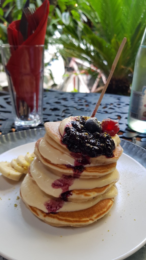 Delicious pancakes with fresh fruit at a café in Tirana, a favorite breakfast spot for digital nomads.
