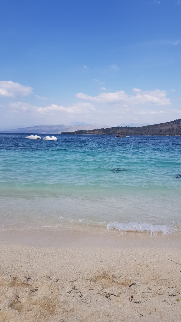 Crystal-clear turquoise waters at Ksamil Beach, a popular destination for digital nomads in southern Albania.