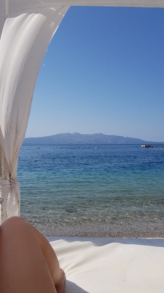 View of the Ionian Sea from a beach canopy at Dream Apartments Saranda, a recommended hotel for digital nomads.