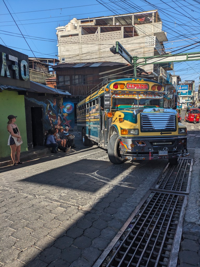 Colorful chicken bus on a bustling street in San Pedro, a typical scene for digital nomads traveling in Guatemala.