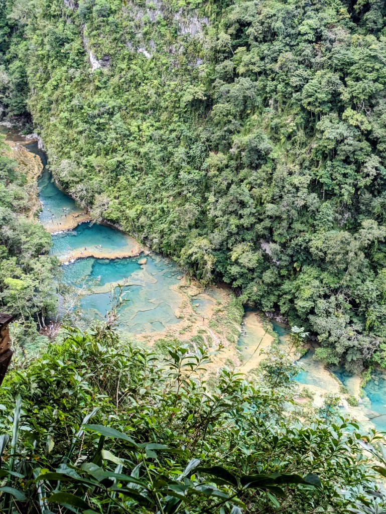 Aerial view of the turquoise pools and lush jungle at Semuc Champey, a natural wonder in Guatemala
