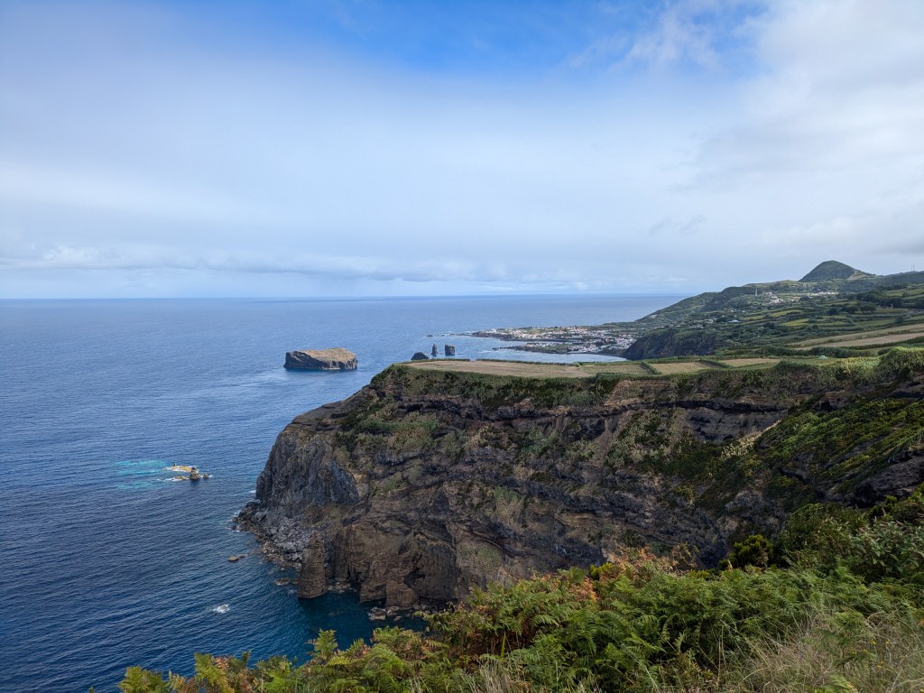 View of the coastline and village of Mosteiros from the cliffs, a stunning spot for digital nomads in the Azores.