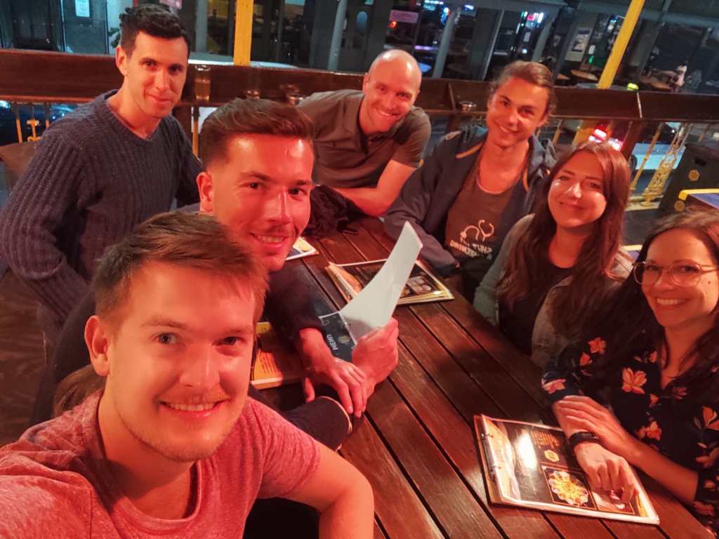 Group of friends at a restaurant, enjoying a social evening, perfect for digital nomads Cape Town.