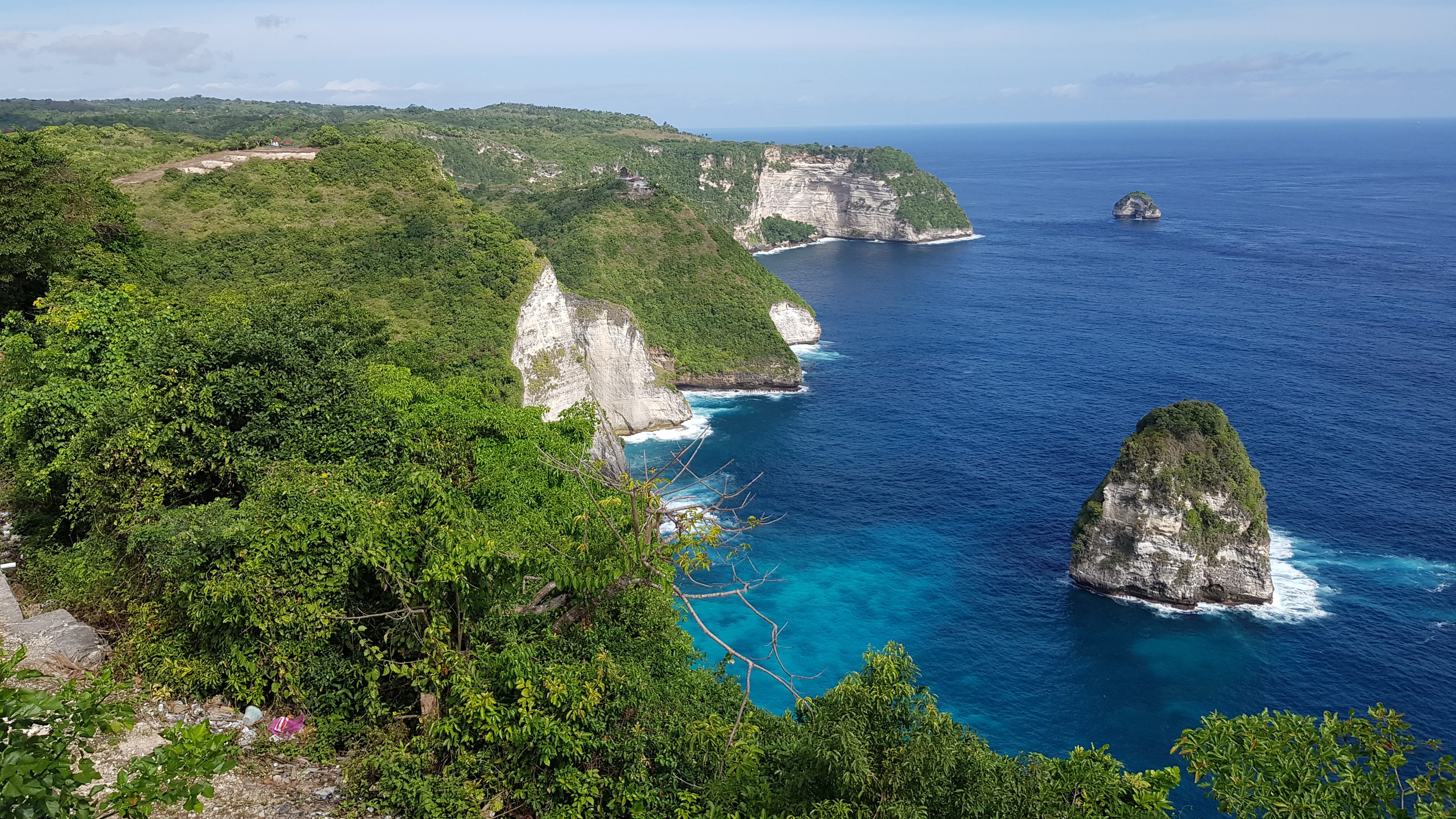 A stunning coastal view of cliffs and turquoise waters in Bali, showcasing the beauty of "how to become a digital nomad" lifestyle.