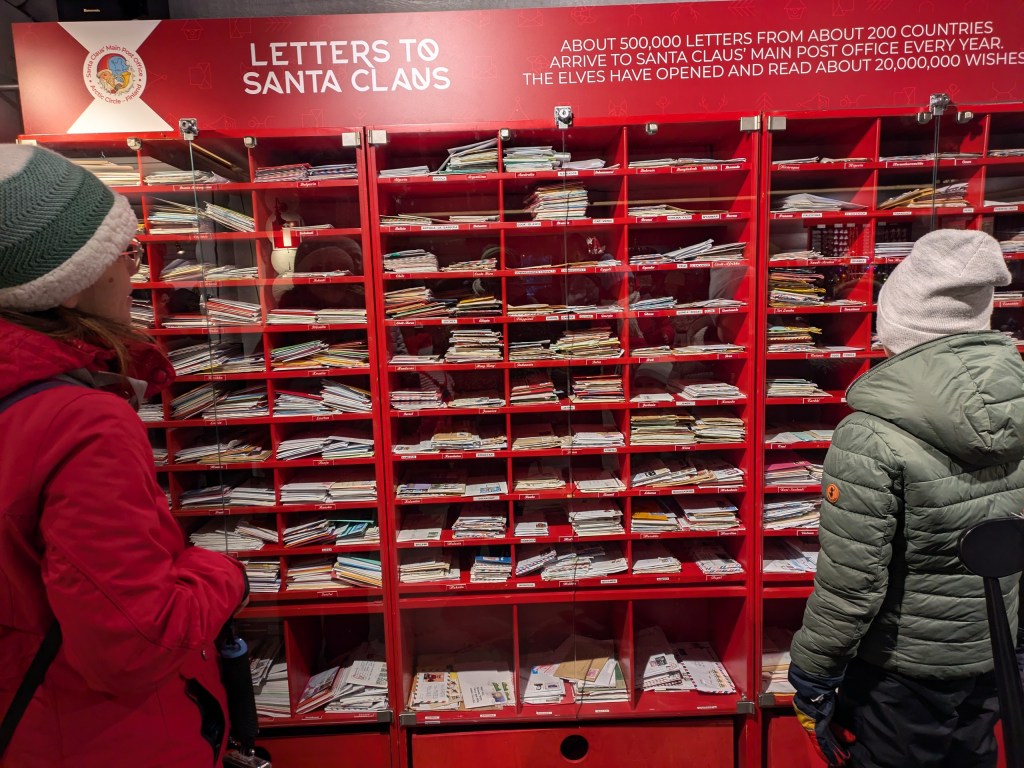 Children posting letters to Santa at the Santa Claus Village post office in Rovaniemi, Lapland, Finland.