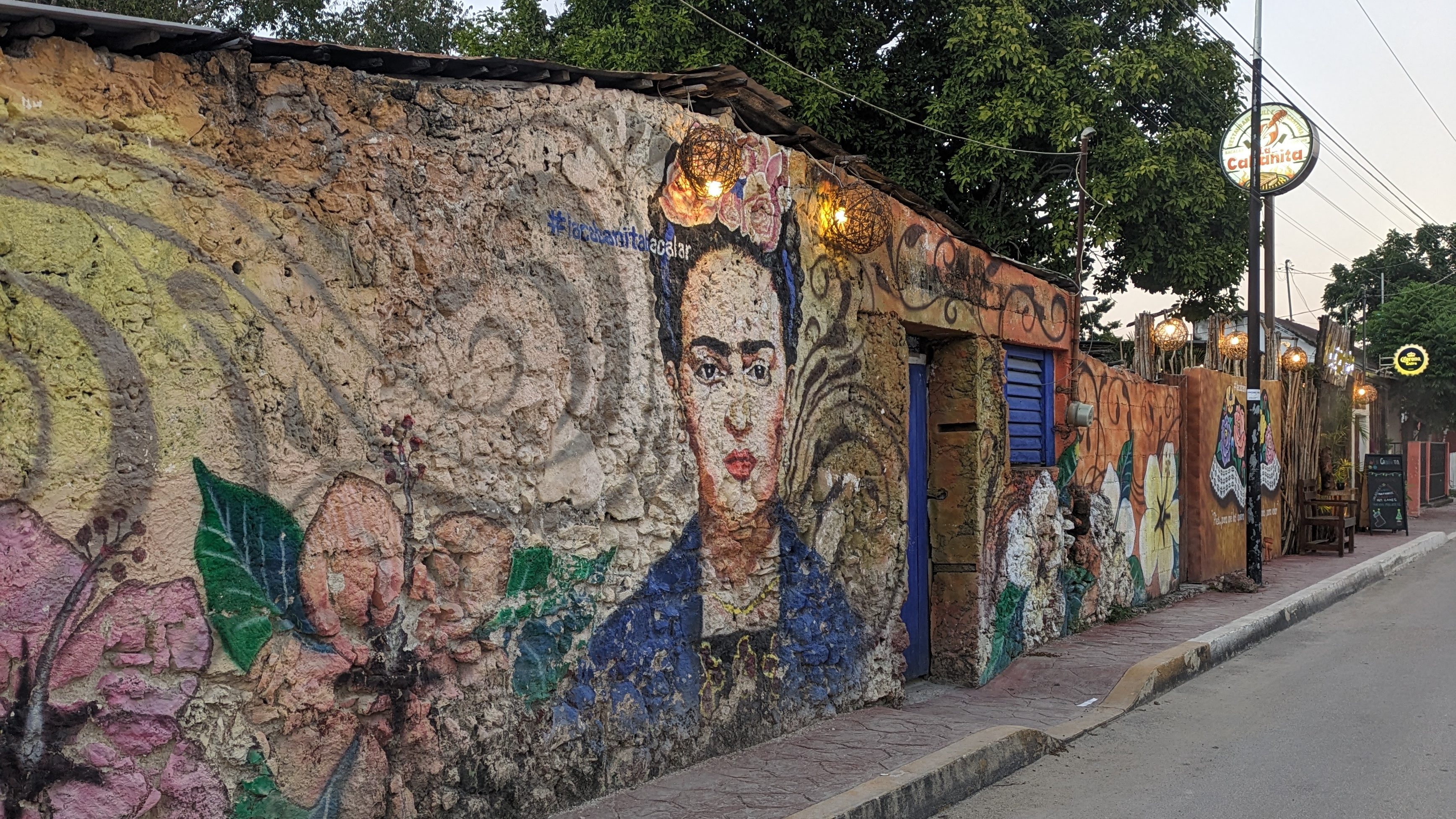 A vibrant mural of Frida Kahlo on a rustic wall in Mexico, reflecting cultural exploration in "what is a digital nomad" lifestyle.