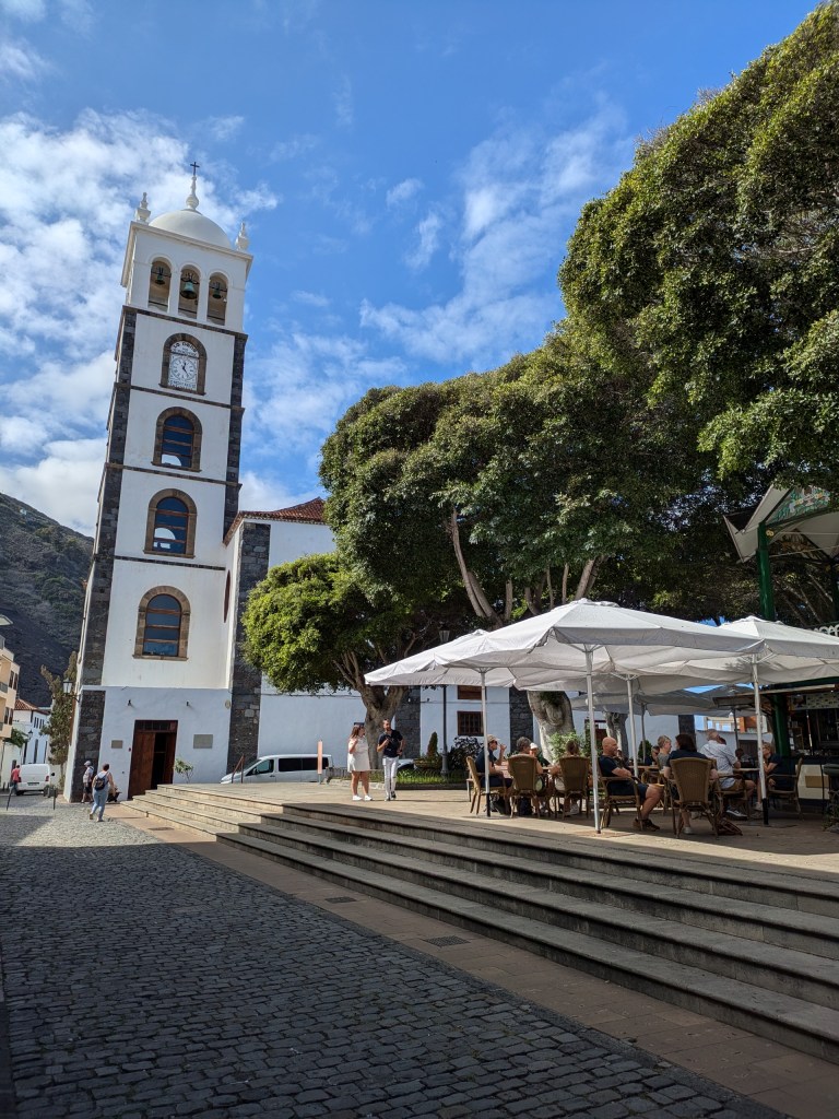 Digital nomad Tenerife Plaza de la Libertad with Iglesia de Santa Ana's bell tower in Garachico, a historic town ideal for remote work.