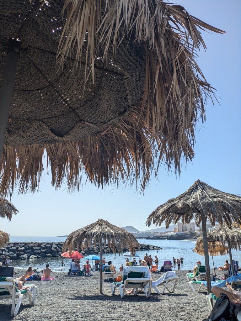 Digital nomad Tenerife Relaxing on the golden sands of Playa de las Teresitas near Santa Cruz.