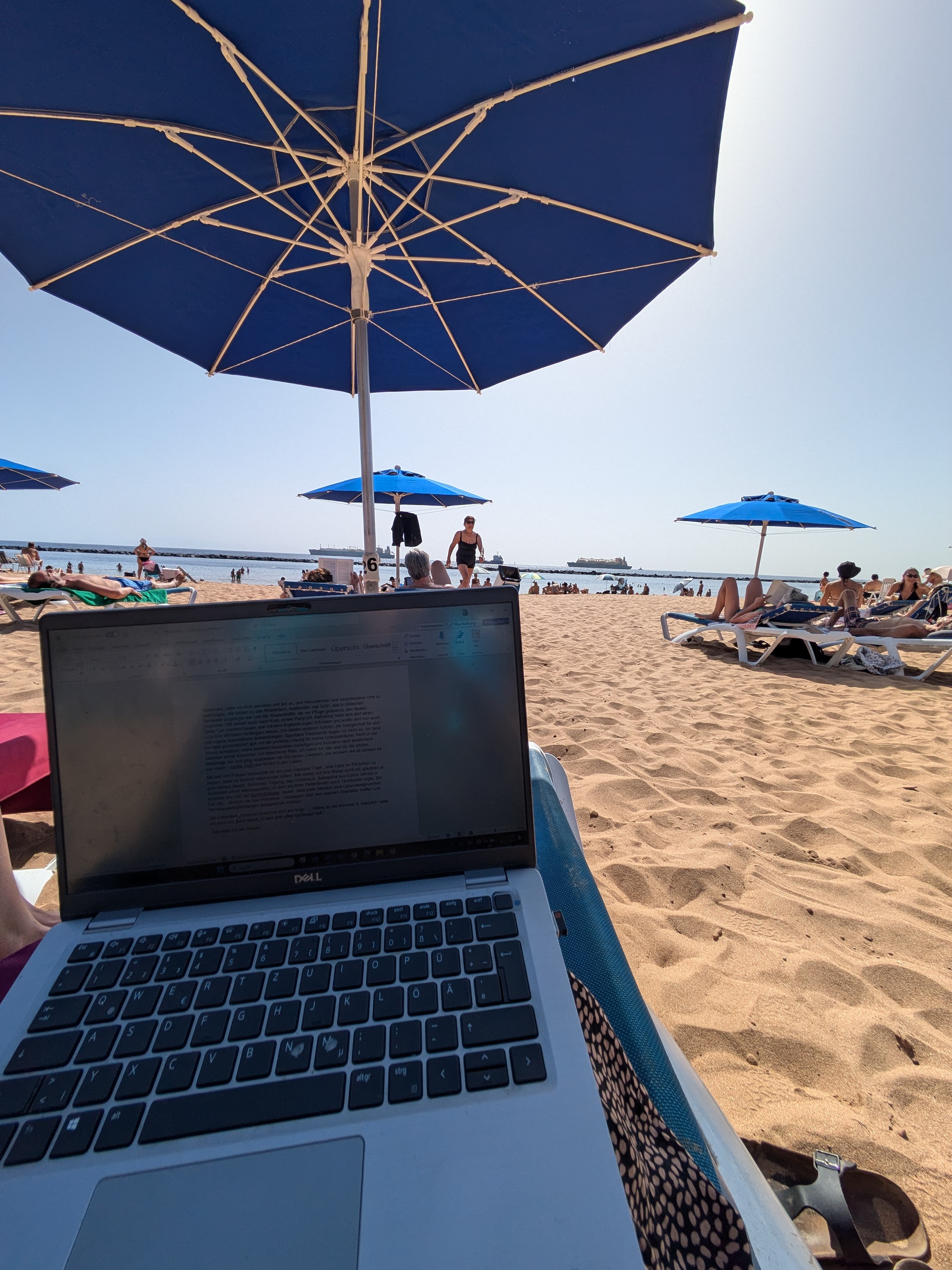 Digital nomad Tenerife Remote work setup on the golden sands of Playa de las Teresitas near Santa Cruz.