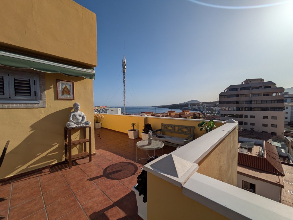 A rooftop Airbnb apartment with a coastal view, showcasing a relaxing stay in "what is a digital nomad" lifestyle.