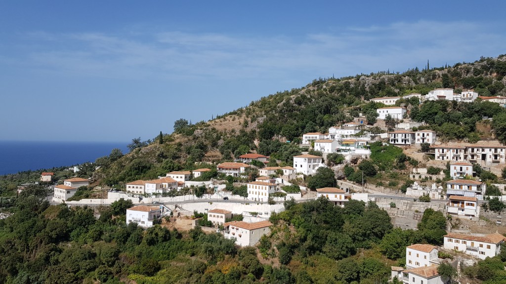 Scenic whitewashed village on a hill in Albania one of the Mediterranean countries with digital nomad visa.