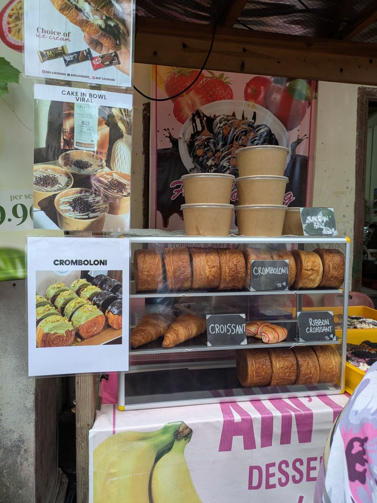 Street food stall in Ipoh showcasing sweet treats on Concubine Lane, a must for digital nomads in Malaysia